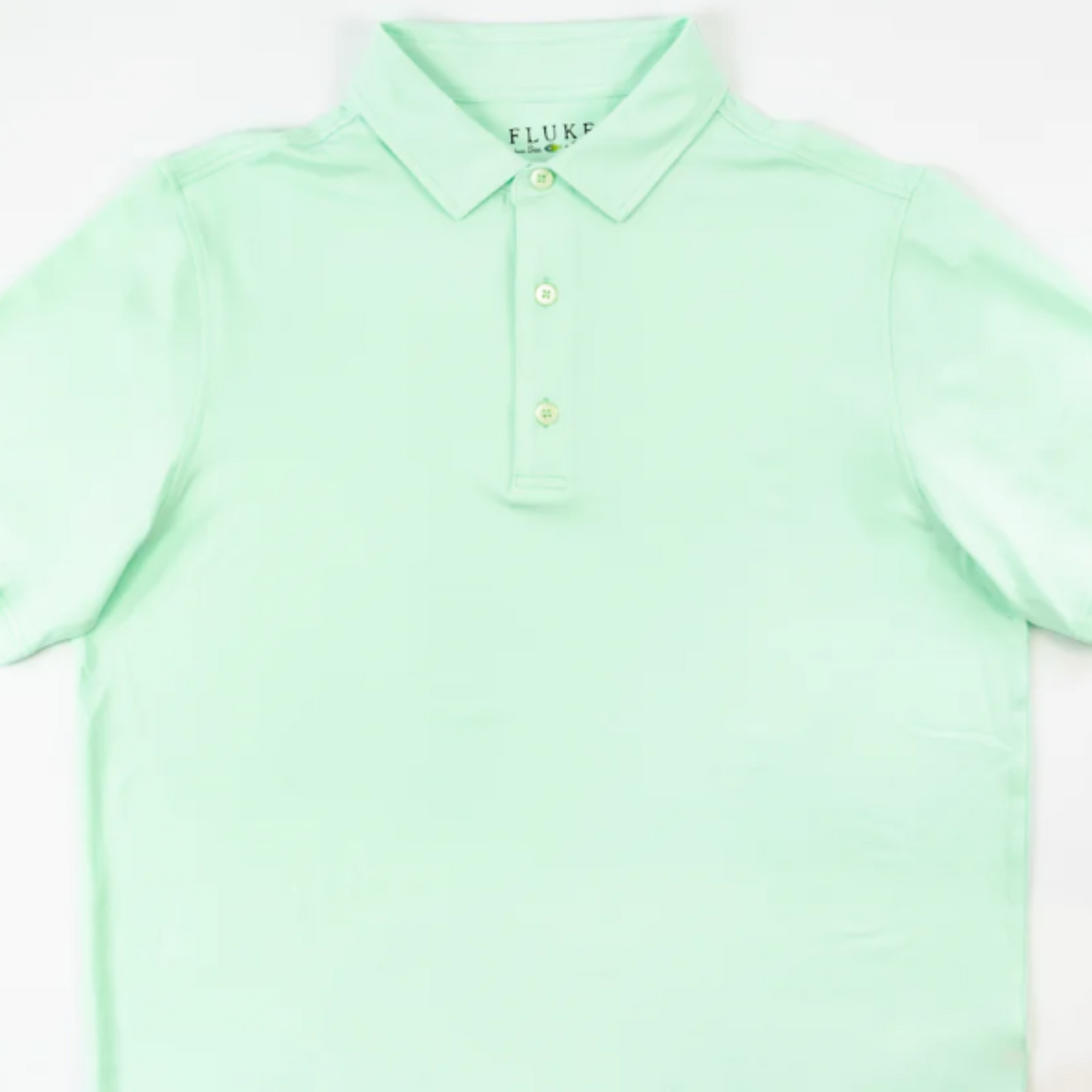 This electric mint green short sleeve polo by Fluke combines polyester and spandex for a lightweight, stretchy fit. Its butter-soft fabric ensures superior comfort, while the buttoned front adds classic style. Perfect for professionals seeking both performance and polished appearance.