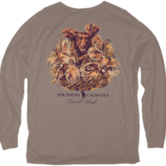 This Southern Casanova Brand long sleeve shirt combines comfort and function with its soft cotton fabric in a natural earth brown tone. Featuring a subtle Boykin Spaniel and quail design, it’s tailored for quail hunting enthusiasts who value ease of movement and durability. A convenient pocket adds practical storage, making it a reliable choice for outdoor activities. Its lightweight, breathable material ensures comfort in variable weather, making it ideal for hunting or casual wear.