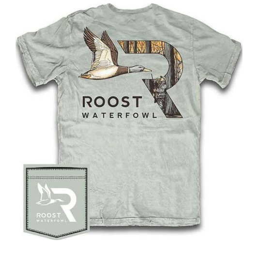 This Duck Hunter Tee from Roost features a bold green body with a striking duck and hunter graphic, complemented by subtle camo accents for an authentic outdoor feel. Designed with short sleeves, it offers comfort and mobility ideal for active wear or casual outings. Crafted to meet the standards of hunting enthusiasts, this tee blends style and function seamlessly.