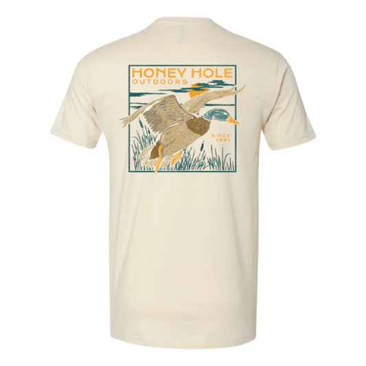 Introducing our Honey Hole brand short sleeve t-shirt, featuring a flying mallard in a night flight scene against a butter cream color background with striking cat tail accents. Perfect for bird and outdoor enthusiasts, this shirt is made with high-quality materials for a comfortable and stylish wear. Stand out from the crowd with this unique and eye-catching design.&nbsp;