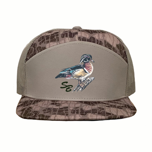 The Wood Duck Cap from Speckle Bellies Brand showcases a detailed embroidered wood duck paired with the SB initials, highlighting quality craftsmanship. Its seven-panel construction ensures a structured fit, while the mesh back provides breathability for extended comfort. Designed for durability and style, this cap is ideal for outdoor enthusiasts seeking a blend of function and distinctive design.