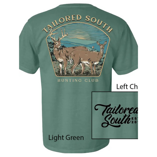 The Tailored South Hunting Club Short Sleeve Pocket Tee is made from 100% cotton, offering comfort and durability for avid deer hunters. It features a detailed graphic of a big buck and a doe with a shooting house in the background on the back, while the front pocket displays the refined Tailored South Script. This tee combines style and function, making it an essential piece for outdoor enthusiasts who appreciate quality hunting apparel.