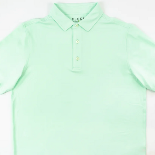 This electric mint green short sleeve polo by Fluke combines polyester and spandex for a lightweight, stretchy fit. Its butter-soft fabric ensures superior comfort, while the buttoned front adds classic style. Perfect for professionals seeking both performance and polished appearance.