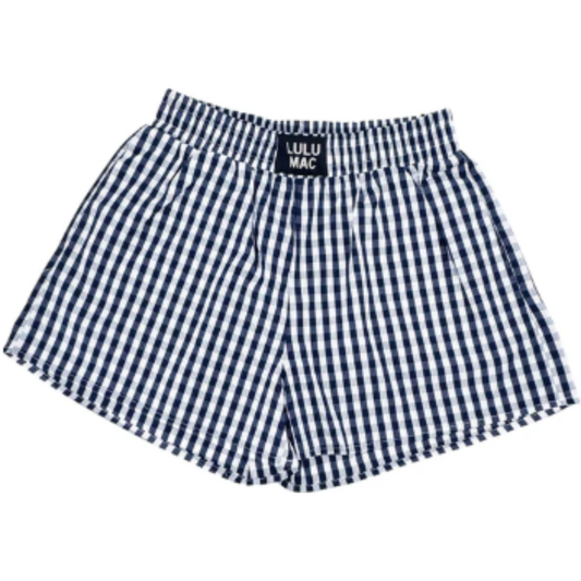 These women's Lulu Mac Navy Gingham Shorts combine timeless style with everyday comfort. Crafted from soft, breathable fabric, their navy and white gingham pattern offers a classic look. Designed with practical pockets, these shorts provide convenient storage while maintaining a flattering fit. Ideal for casual outings or relaxed days, they deliver both ease and elegance in one versatile piece.