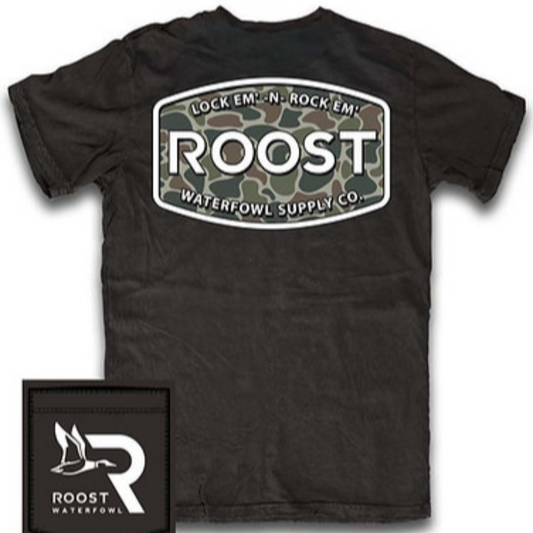 The Black Roost Label Short Sleeve Tee is a premium men's cotton tee designed for waterfowl enthusiasts. Featuring a comfortable, durable fabric, this black shirt highlights a camo-patterned pocket and the iconic Roost logo, combining functionality with style. Ideal for outdoor activities, it honors the duck hunting tradition while providing everyday wearability.
