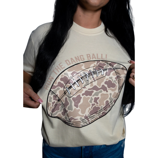 The Run the Dang Ball Tee combines camouflage patterning with a bold buttercream yellow accent, making it perfect for football enthusiasts who value both style and sport. Crafted for comfort and durability, this tee supports active movement while showcasing your commitment to the game. Ideal for training, casual wear, or game day, it blends performance with standout design.